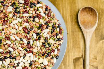 legumes in a dish on wood, close up, background