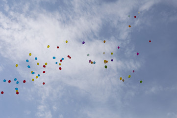 balloons in the sky against clouds