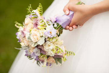 Beautiful wedding bouquet in hands of the bride