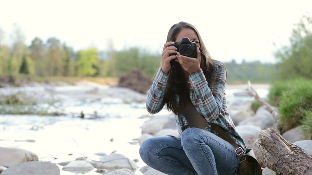 Young girl taking pictures outdoors