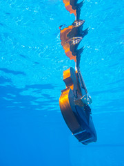 Violin underwater in the pool