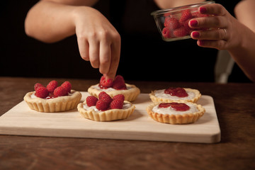 woman preparing raspberry cup cakes