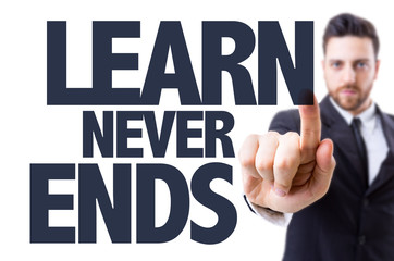 Business man pointing the text: Learn Never Ends