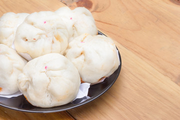 Fototapeta na wymiar Chinese steamed buns on wood background.