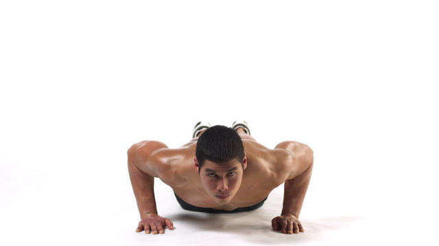 Wide shot of an athletic ethnic man doing push ups