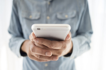 Men have a smart phone with both hands