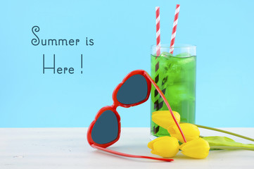 Summer Is Here concept with red heart shape sunglasses