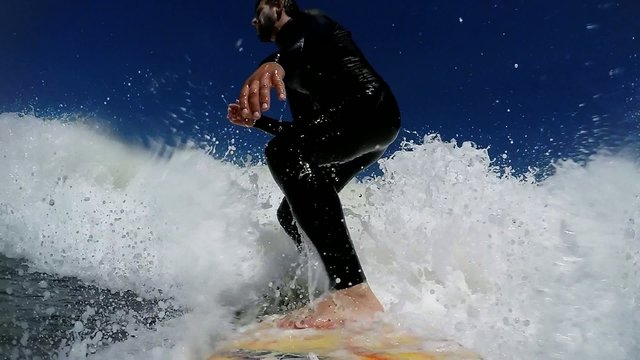 Young man enjoying the surfing in Waves.