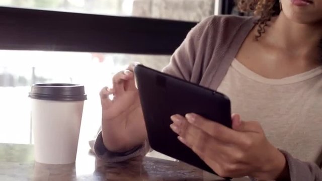 Woman using a Tablet in a Cafe