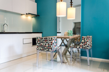 Modern small kitchen interior. / Contemporary mini kitchen with table sets.