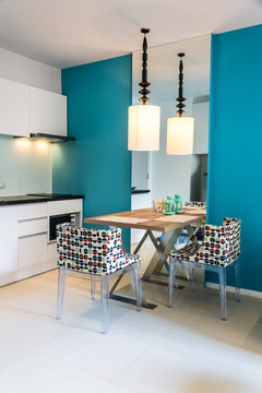 Modern small kitchen interior. / Contemporary mini kitchen with table sets.