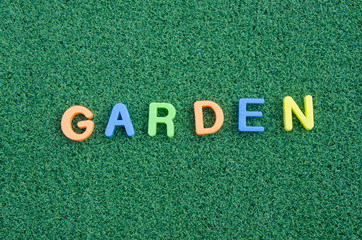 garden letter message on green grass background