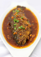 Delicious chinese fish meal served with spicy sauce.