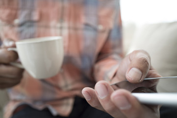 Men have a smart phone while drinking coffee