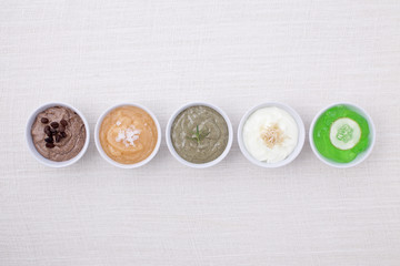 variety of body scrubs on cotton background