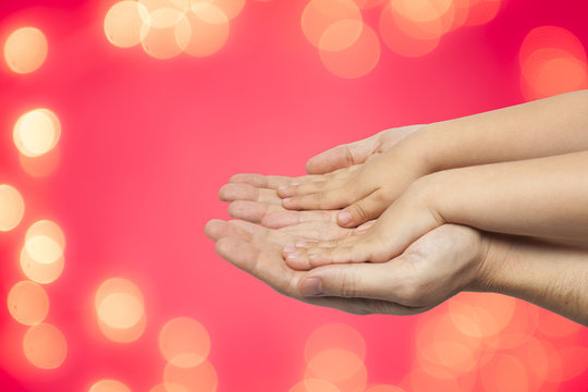 father and son holding hands on christmas lights background