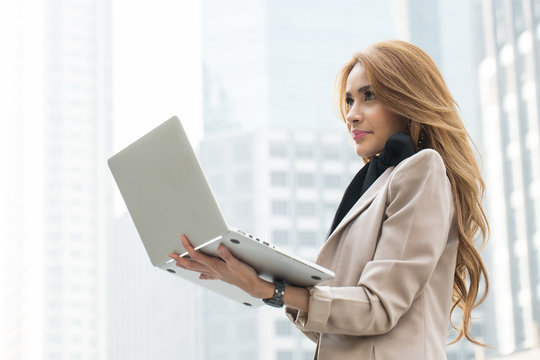 Businesswoman holding laptop for search and check information re