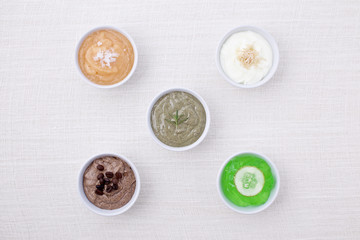 variety of body scrubs on cotton background