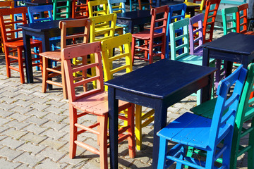 colorful wooden chairs on the street