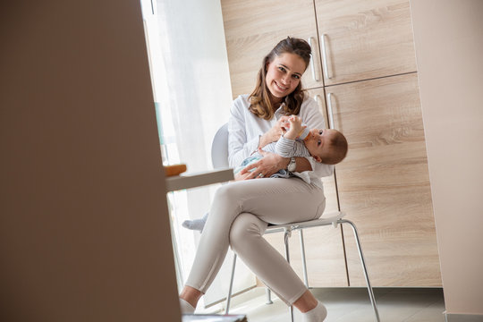 Mother feeding her baby boy.