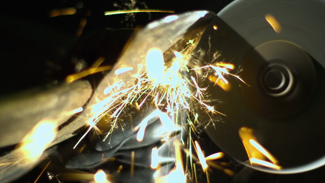 A tool being sharpened on a grinder