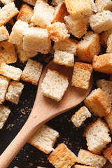 Homemade croutons in a pan close-up. vertical top view