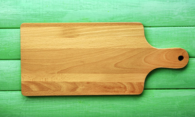 Cutting board on wooden background