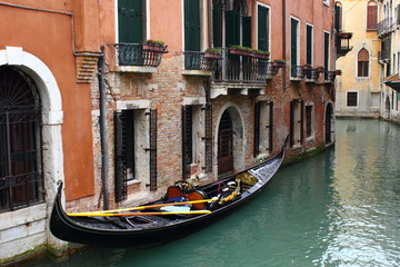 Naklejka na ściany i meble Parking gondola in narrrow canal in Venice. 