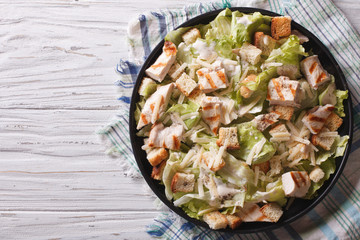 Caesar salad with chicken horizontal top view 
