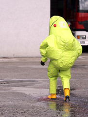 firefighter with yellow protective gear against biological risk
