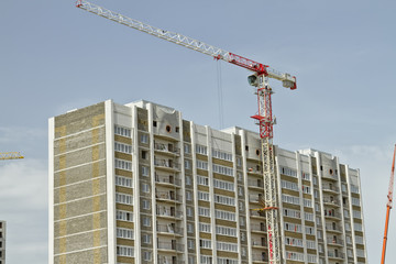 Fototapeta na wymiar brick construction of apartment houses with modern cranes