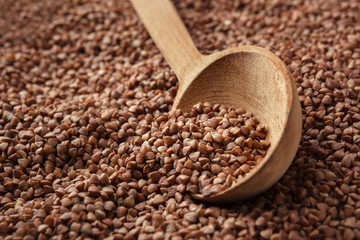 Closeup of buckwheat with wooden spoon.