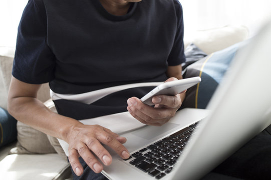 Men using a laptop and smartphone