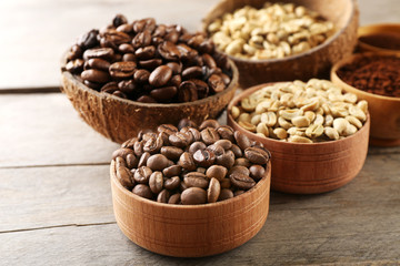 Various of coffee in small dishes on wooden table, closeup