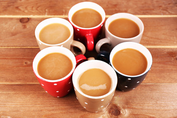 Cups of cappuccino on wooden background
