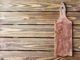 Cutting board on wooden background