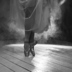 The feet of  ballerina  in smoke in black&white