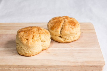 Scone on wooden plate.