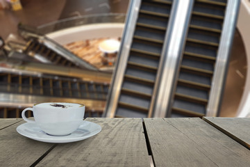 Defocus with terrace wood and cappuccino coffee with escalators