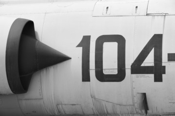 Fighter aircraft fuselage metallic detail with number 104