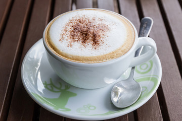 Cappuccino or latte coffee on wooden table.