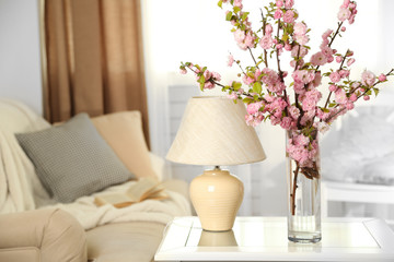 Spring bouquet in vase, on table, on home interior background