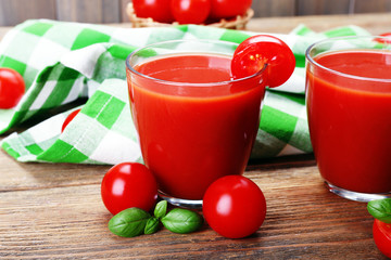 Glasses of tomato juice with vegetables on table close up