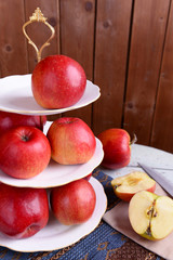Fototapeta na wymiar Tasty ripe apples on serving tray on wooden background