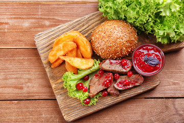 Beef with cranberry sauce, roasted potato slices 