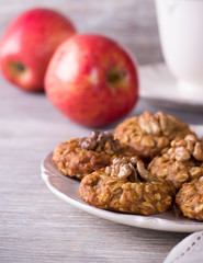 Oatmeal cookies with walnuts, apples and a cup of tea 