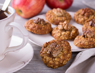 Oatmeal cookies with walnuts, apples and a cup of tea 