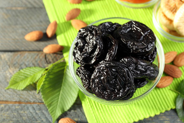 Dried fruits and almonds with leaves on green napkin, closeup