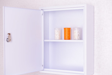 Medicine chest with bottles of pills, closeup