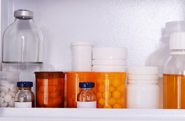 Medicine chest with bottles of pills, closeup